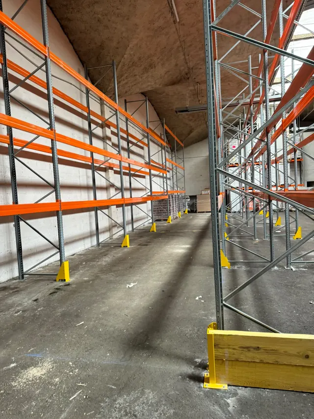 Rack à palettes galvanisé et orange dans un bâtiment en exploitation